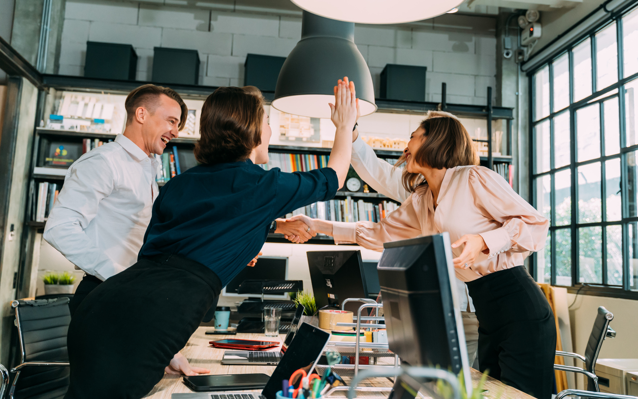 Group of business people giving high-five