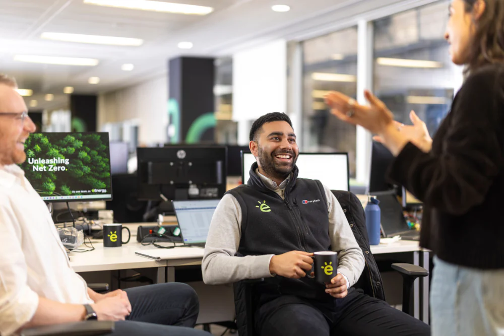 About us - eEnergy team talking in office